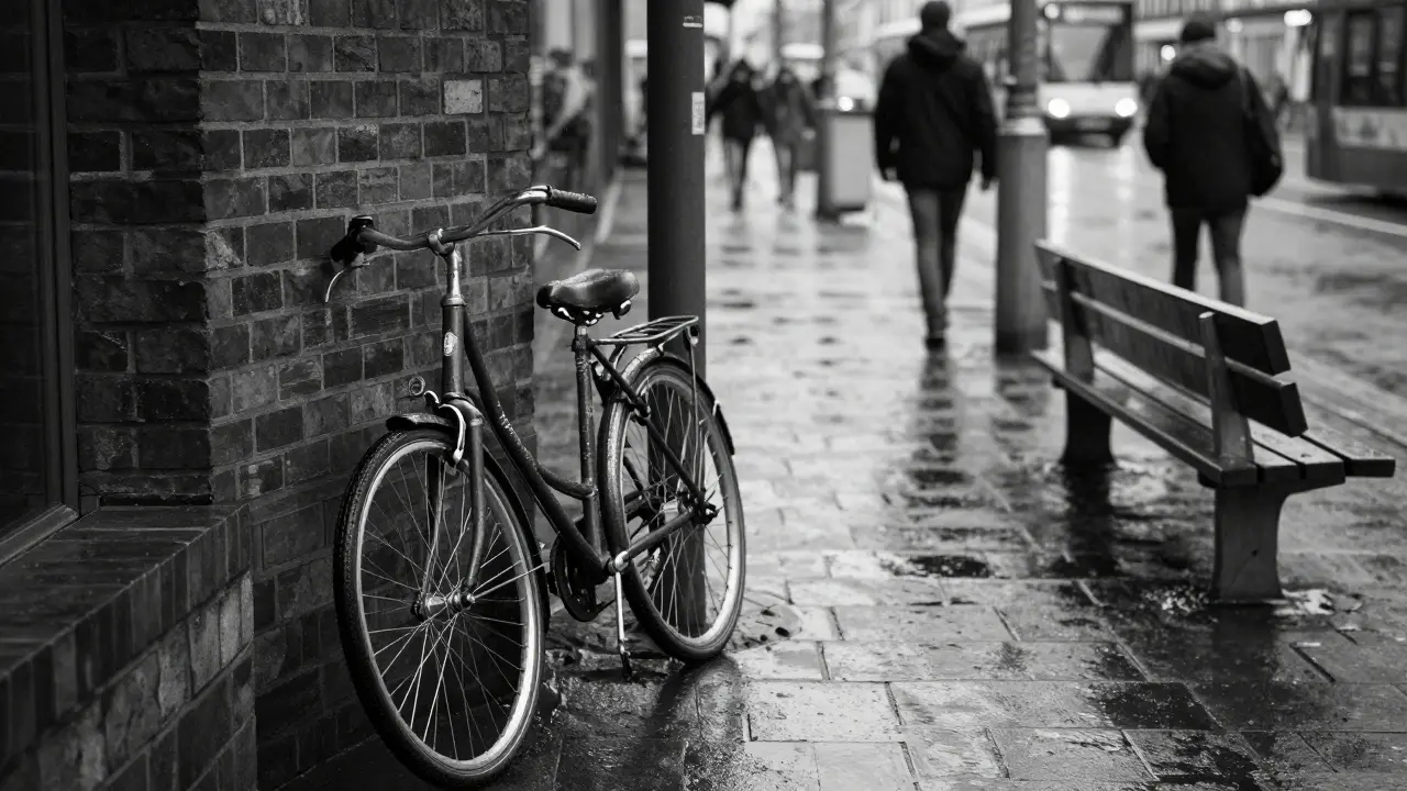 A single wet bicycle leaning against a wall under a Munich tram stop, rain glistening on metal.